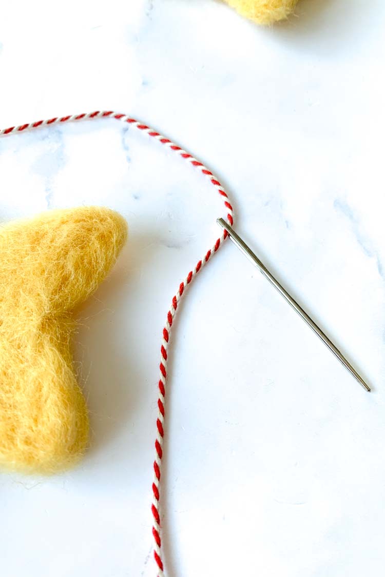 how to needle felt a star with a cookie cutter - attaching a hanging thread